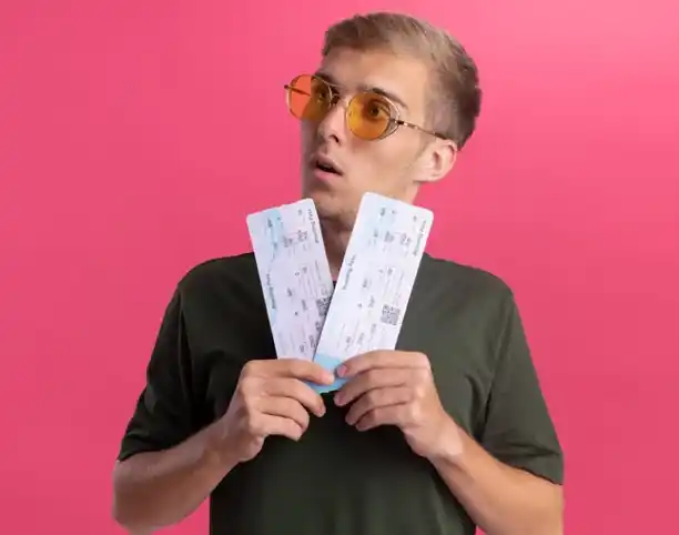 Shocked man holding tickets, illustrating the frustration caused by Ticketmaster scams