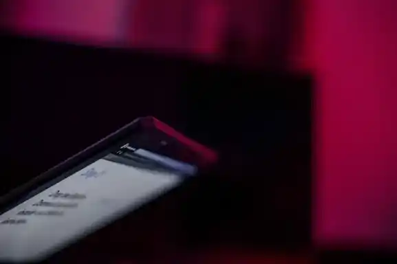 Close-up of a smartphone screen with dim lighting, symbolizing potential Twitter scam messages