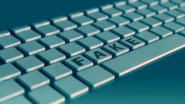Close-up of a computer keyboard with keys spelling "FAKE", symbolizing fake website examples online