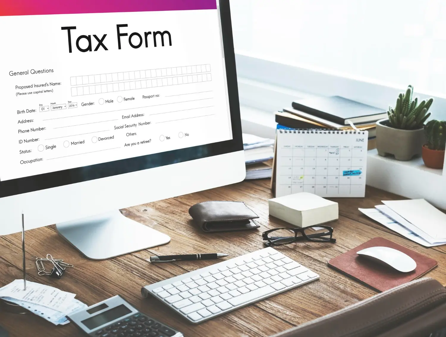 Workspace with tax form on screen for homeowners reviewing when are property taxes due in Iowa and preparing required documents